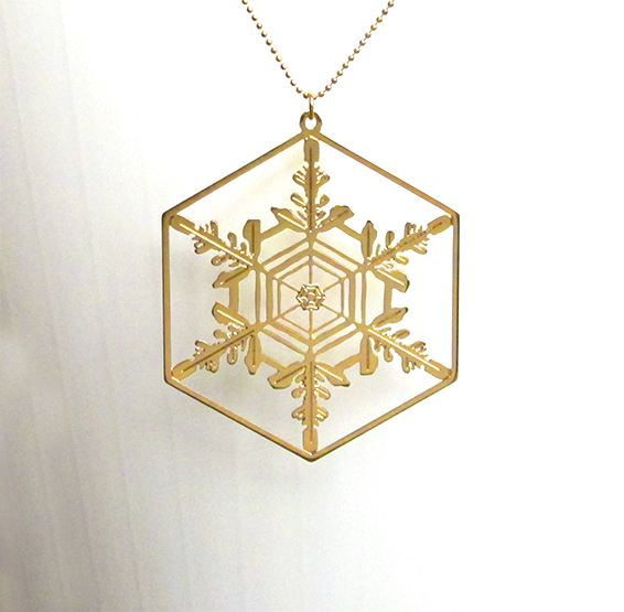 microscopic depiction of a snowflake crystal gold necklace by Delftia science jewelry